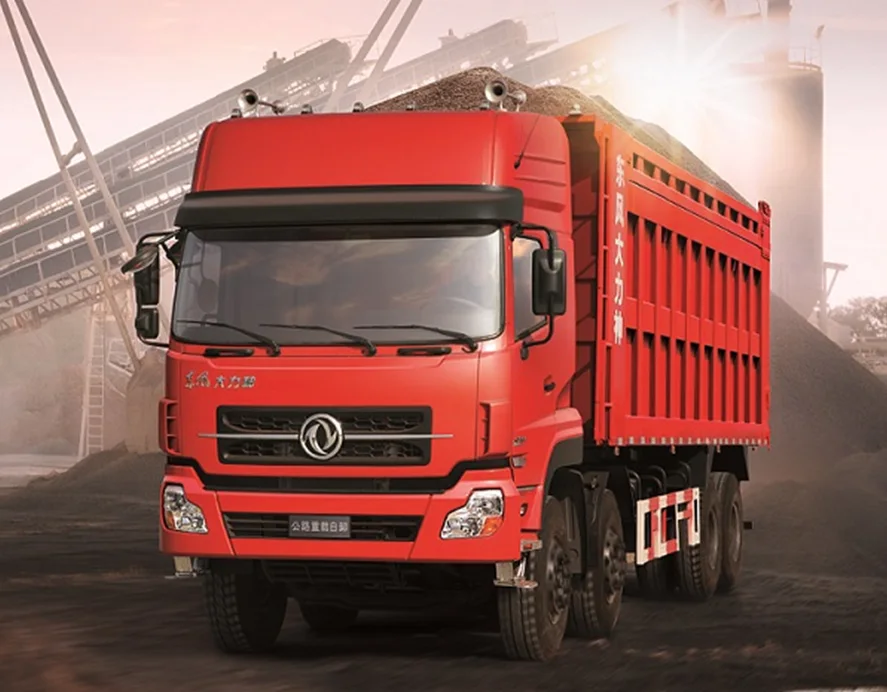 Red Dongfeng heavy-duty dump truck (tipper truck) loaded with bulk materials at a construction site, ideal for mining and infrastructure projects.